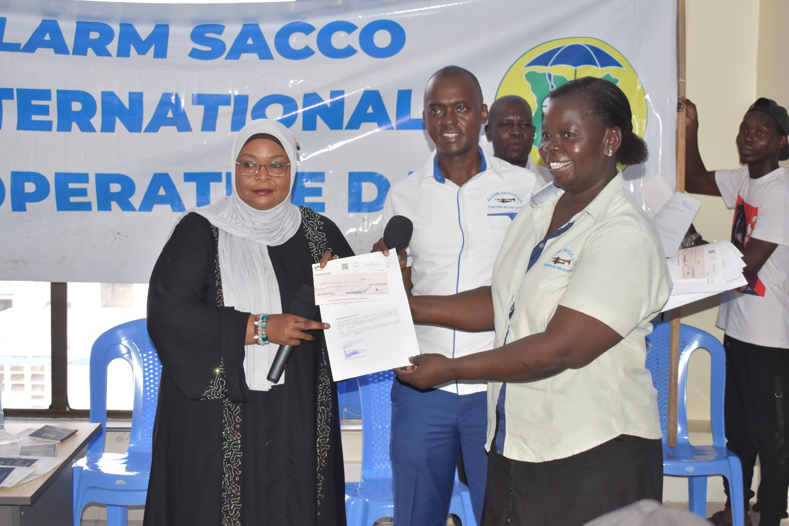 Member proudly holding a newly received certificate
