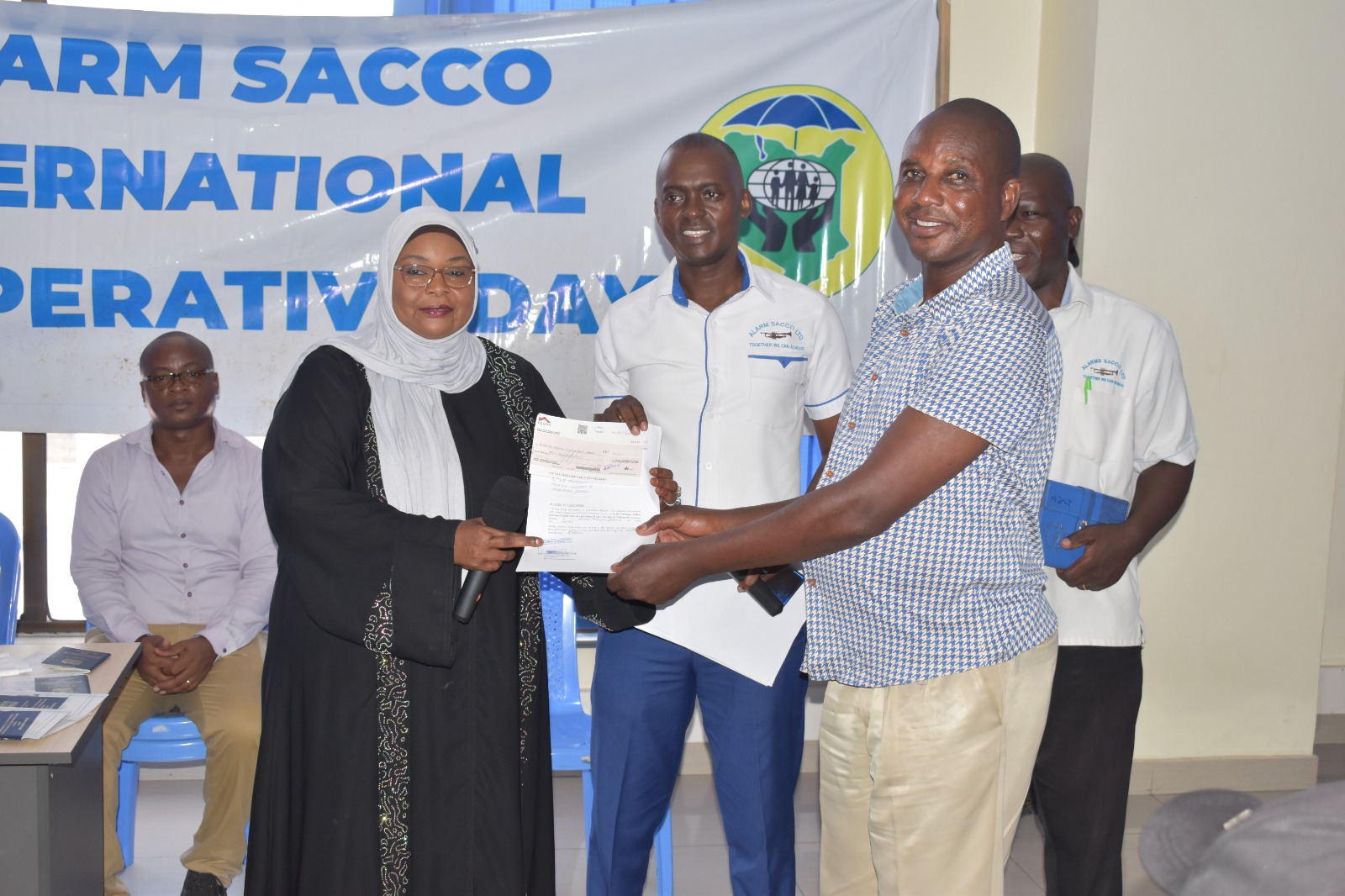ALARM SACCO staff and members during a certificate event